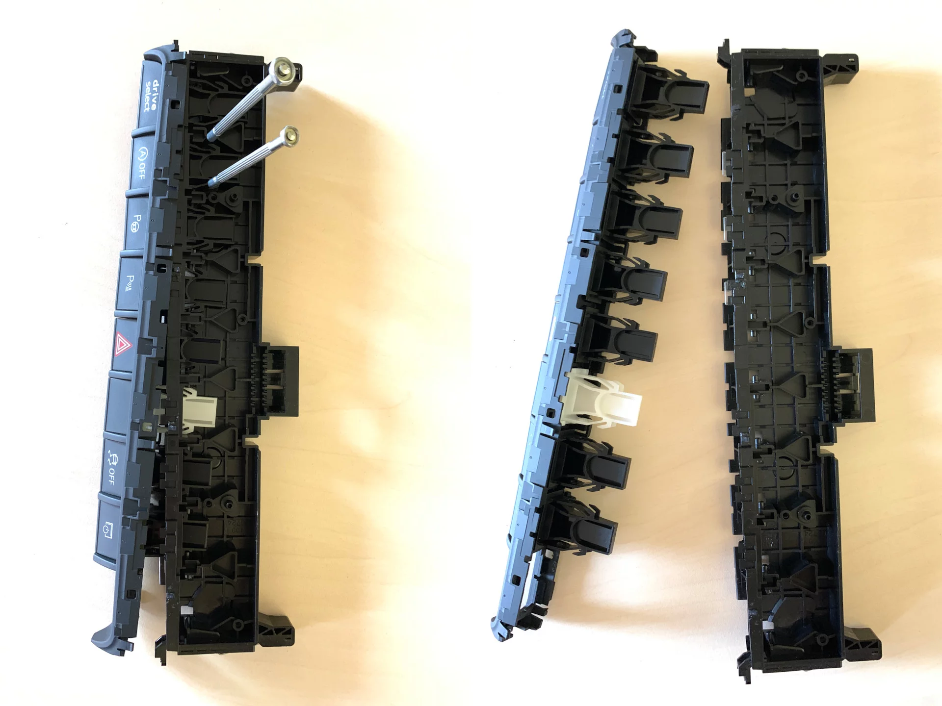 The next step is much harder: you need to remove the plastic with bridges, but it is held by all the buttons on the panel at the same time.